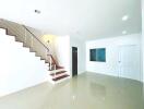 Spacious and bright stairway area with tiled flooring in a modern home