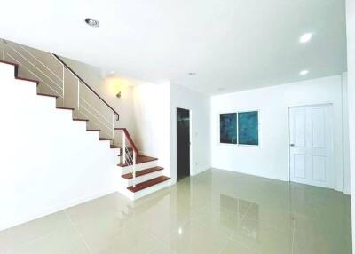 Spacious and bright stairway area with tiled flooring in a modern home