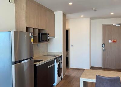 Modern kitchen with stainless steel appliances and wooden flooring