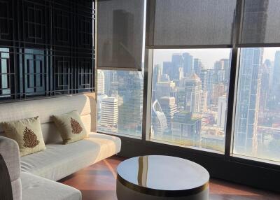 Modern living room with floor-to-ceiling windows offering city views