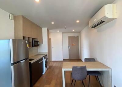 Modern kitchen with stainless steel appliances and wooden flooring