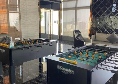 Spacious recreation room with foosball tables and modern design