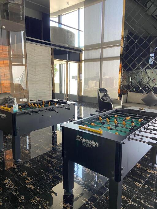 Spacious recreation room with foosball tables and modern design