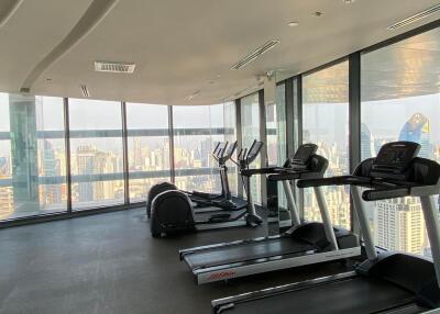 High-rise building gym with treadmills overlooking the city