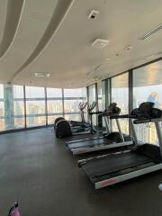 High-rise building gym with treadmills overlooking the city