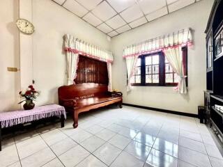 Spacious and well-lit bedroom with traditional furnishings