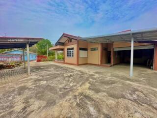 Spacious residential driveway with covered parking and house entrance