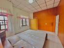 Cozy bedroom with large bed and wooden paneling