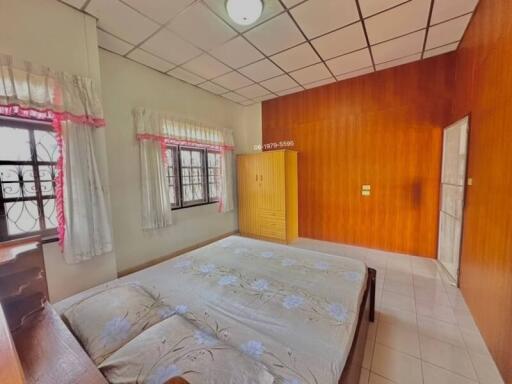 Cozy bedroom with large bed and wooden paneling