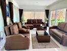 Spacious and well-furnished living room with ample seating and natural light