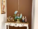Elegant hallway console table with decorative items and art