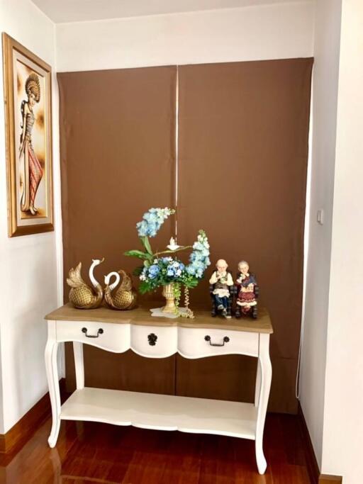 Elegant hallway console table with decorative items and art