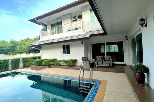 Modern two-story house with a swimming pool and outdoor seating