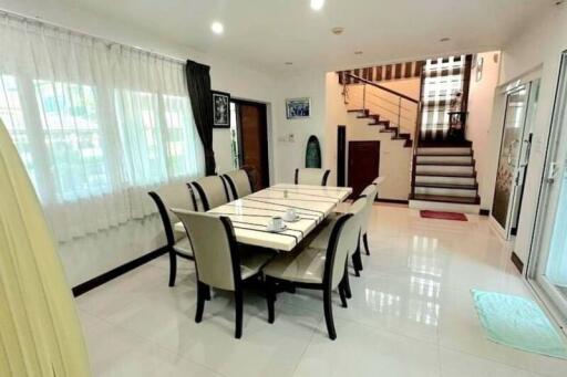 Spacious dining room with stairs leading to the second level