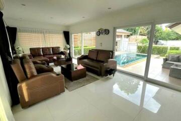 Spacious living room with pool view and modern furniture