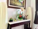 Elegant console table with decorative items and artwork in a living space