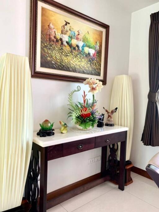 Elegant console table with decorative items and artwork in a living space