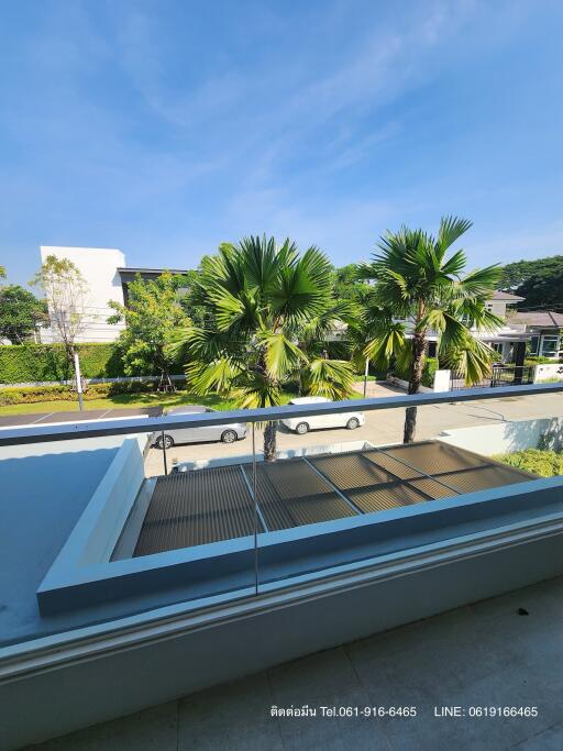 Spacious balcony with a view of palm trees and clear skies