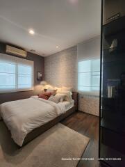 Cozy bedroom with modern decor and ample lighting