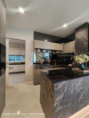 Modern kitchen with black cabinets and marble countertops