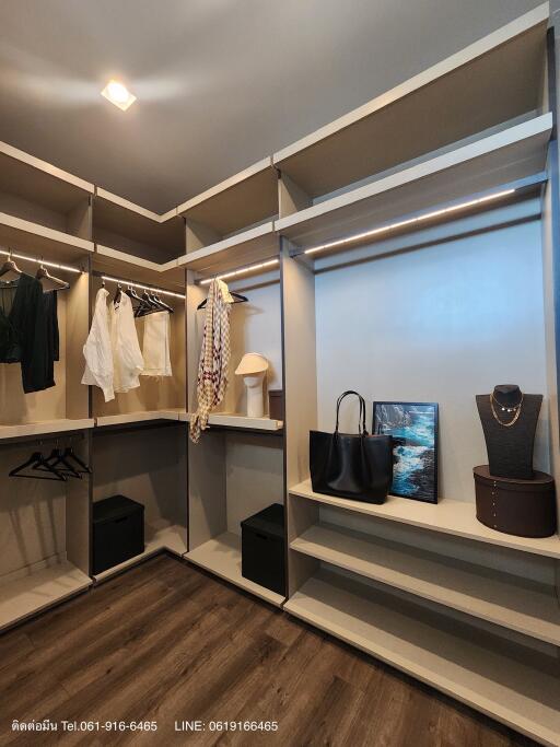 Spacious walk-in closet with custom shelving and integrated lighting