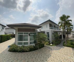 Modern residential home exterior with landscaped pathway