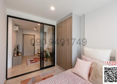 Cozy bedroom with sliding glass door, wooden flooring, and modern design
