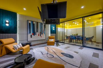 Modern living area with vibrant yellow walls, comfortable seating, and stylish decor