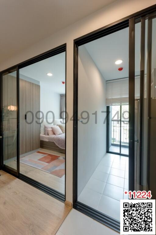 Modern bedroom with direct access to balcony seen through sliding glass doors