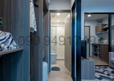 Modern hallway view with built-in shelves leading towards the interior of an apartment