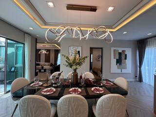 Elegant dining room with modern chandelier and artwork