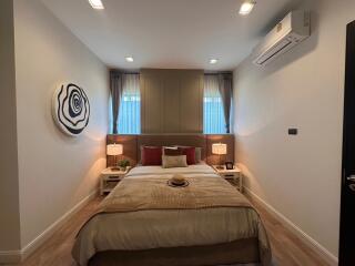Cozy modern bedroom with king-sized bed and artistic decor