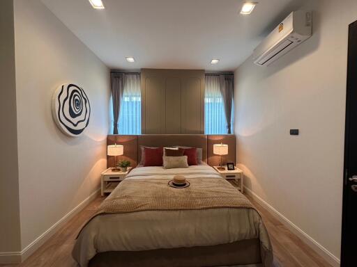 Cozy modern bedroom with king-sized bed and artistic decor