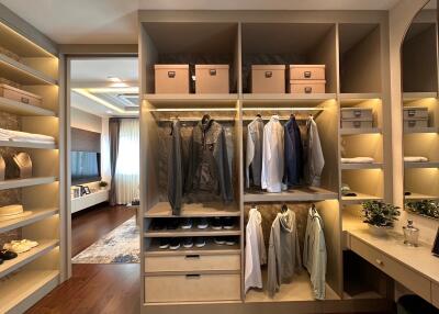 Spacious walk-in closet with organized shelving and lighting