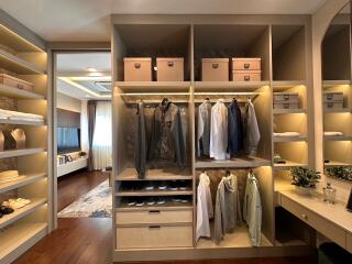 Spacious walk-in closet with organized shelving and lighting
