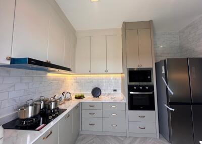 modern kitchen with stainless steel appliances and white cabinets