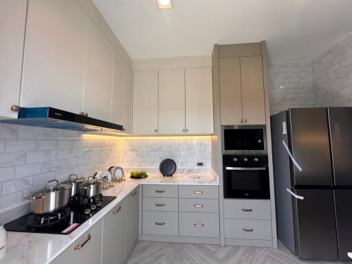 modern kitchen with stainless steel appliances and white cabinets