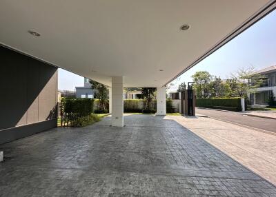 Modern building entrance with spacious covered parking area