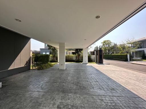 Modern building entrance with spacious covered parking area