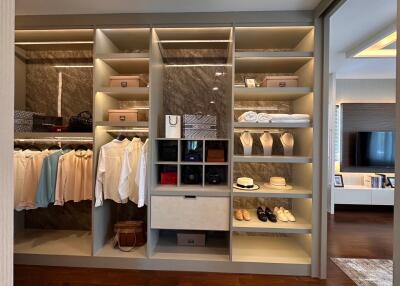 Elegant walk-in closet with ample shelving and organized wardrobe