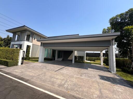 Modern two-story house with spacious driveway and carport