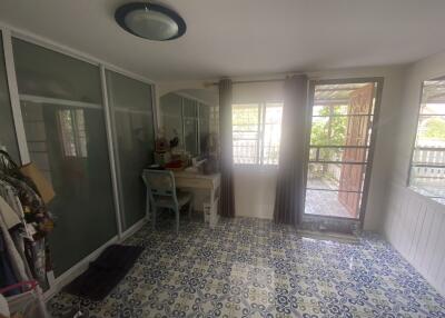 Bright and airy enclosed sunroom with patterned floor and sliding doors