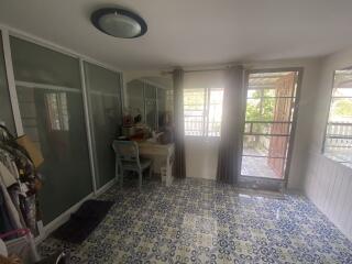 Bright and airy enclosed sunroom with patterned floor and sliding doors