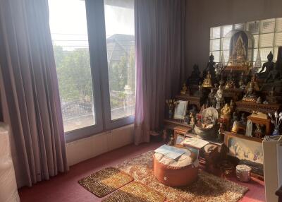 Spacious room with religious shrine and ample natural light
