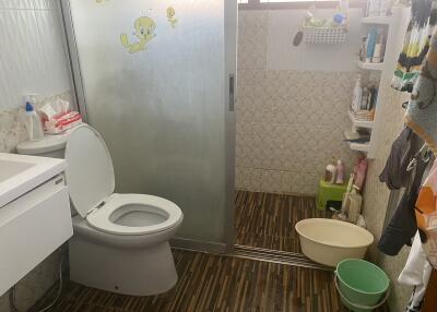 Compact bathroom with cartoon wall decals and essential fixtures