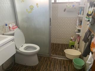 Compact bathroom with cartoon wall decals and essential fixtures