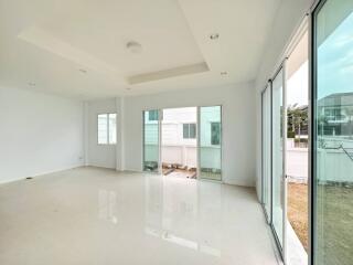 Spacious and bright empty living space with large windows and glossy tiled flooring