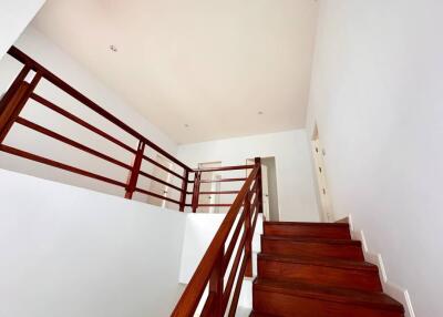 Wooden staircase with white walls in a modern home