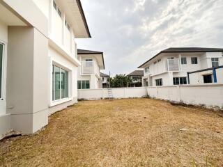 Suburban house exterior with open backyard space