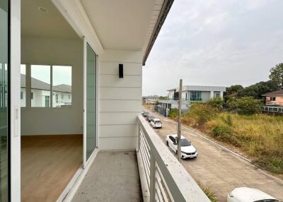 Spacious balcony with a street view in a residential neighborhood